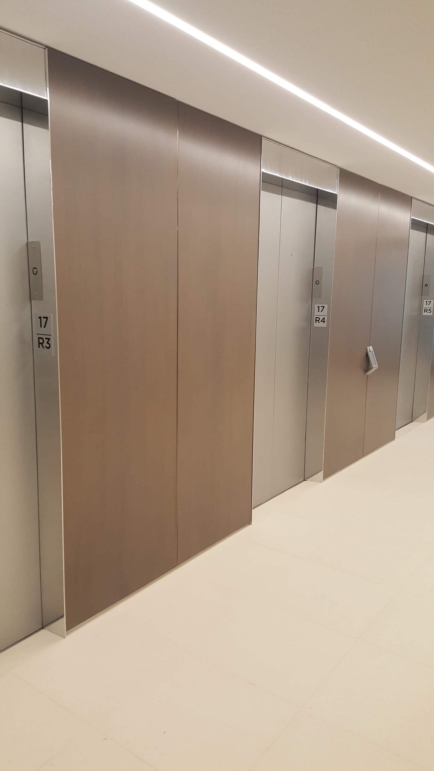 A row of doors in a room with a floor.