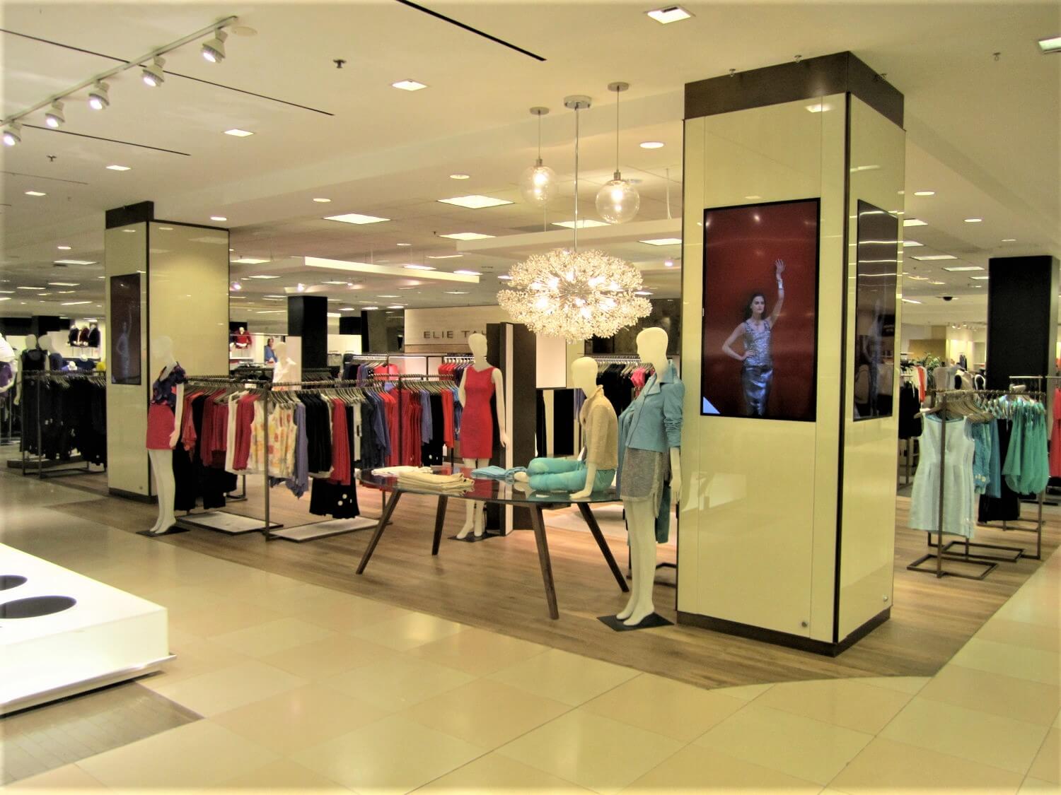 A man is standing in front of a display case.