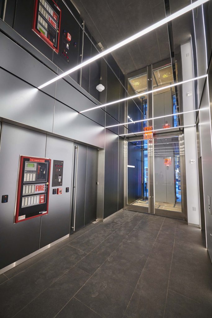 A hallway with a vending machine and elevator.