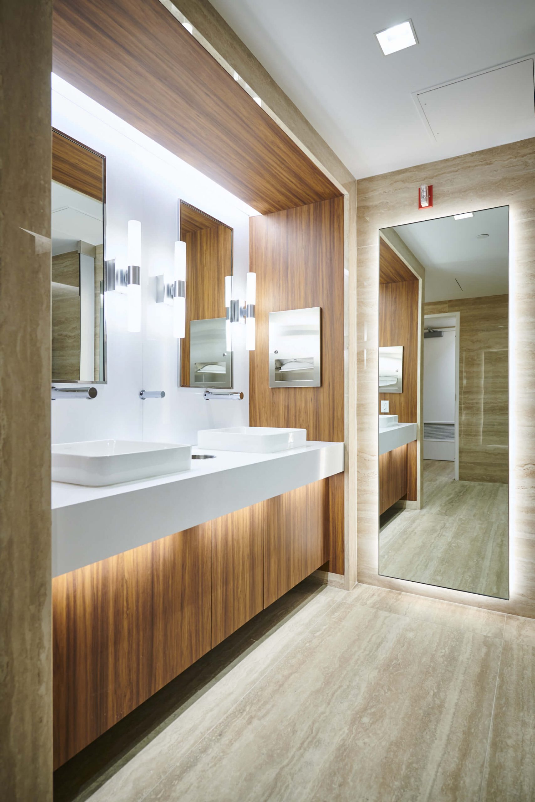 A bathroom with two sinks and a large mirror.