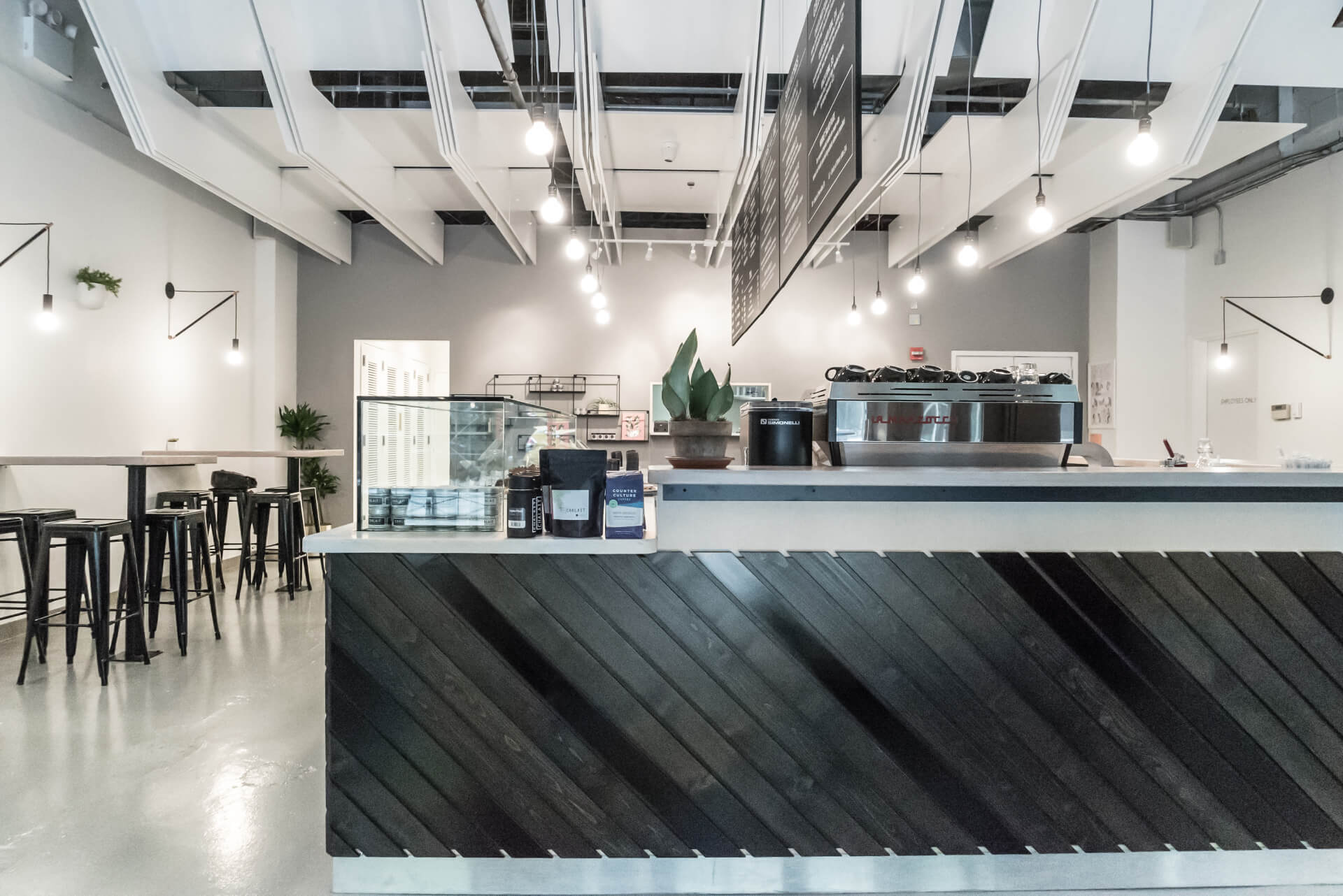 A restaurant with a black and white counter.