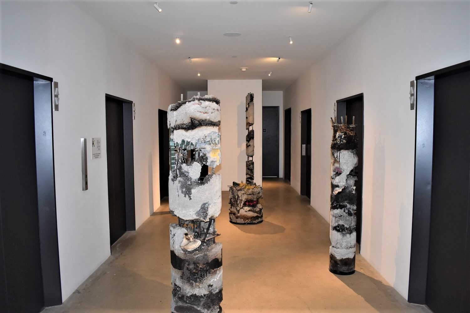 A hallway with many sculptures in it