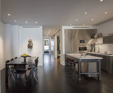 A kitchen with a table and chairs in it