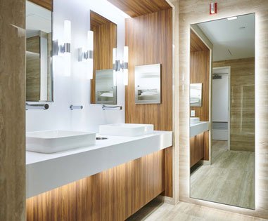 A bathroom with two sinks and mirrors in it