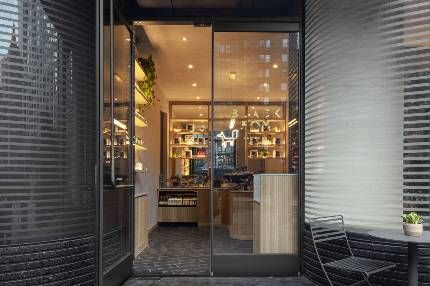 A store front with glass doors and shelves.